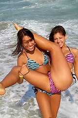 seducing bikini girls smiling in camera
